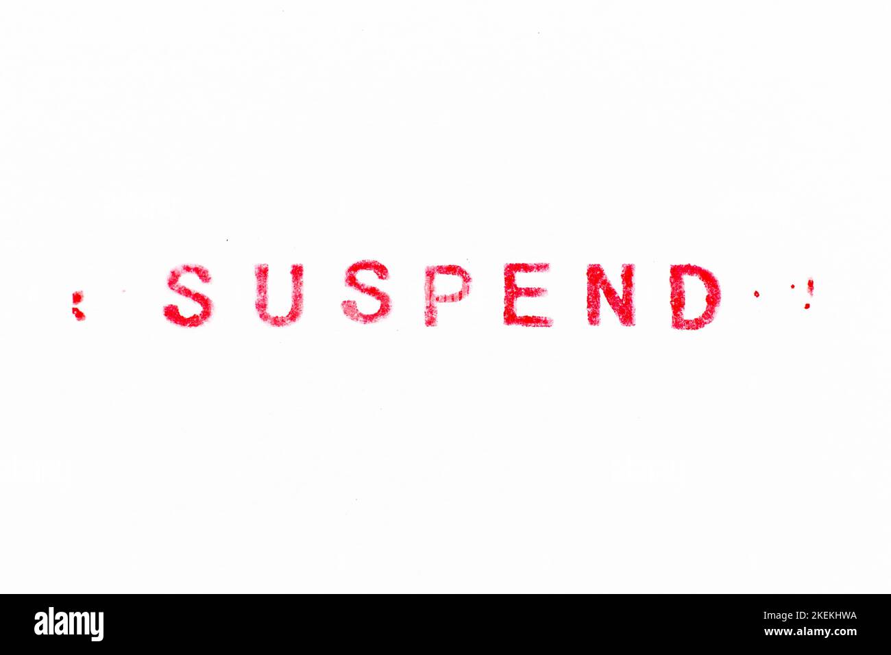 Red color ink rubber stamp in word suspend on white paper background ...