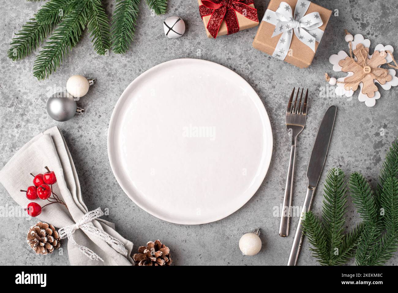 Christmas place setting on gray table. Stock Photo