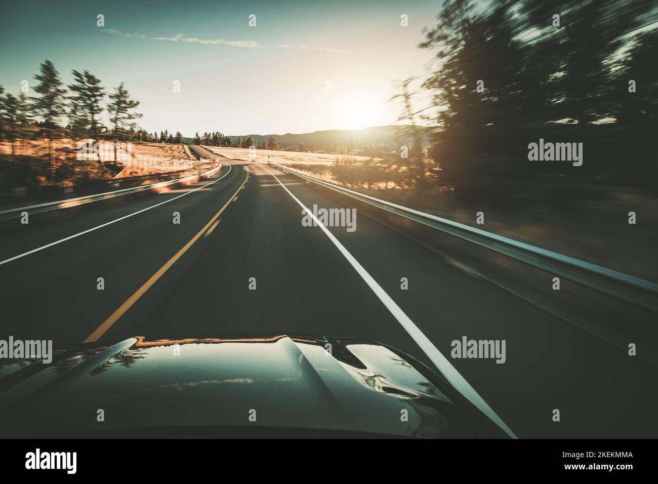 Traffic Free Open Road Driver During Sunset. Motion Blur. Car Drive Theme. Stock Photo