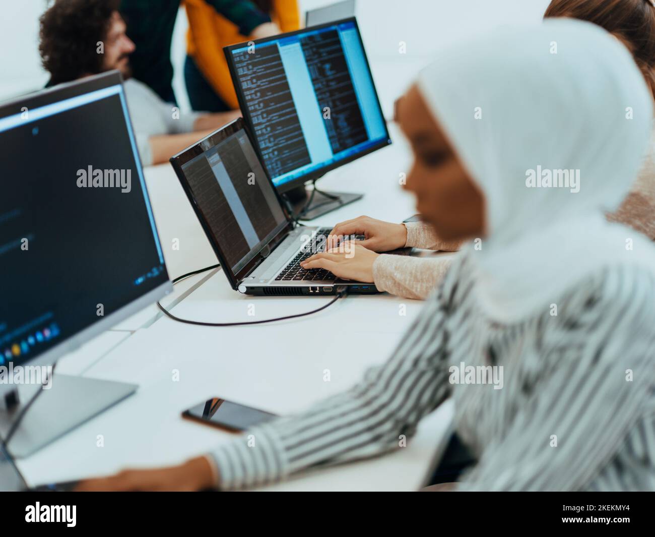 Group of multi-ethnic colleagues working on desktop computers, laptop ...