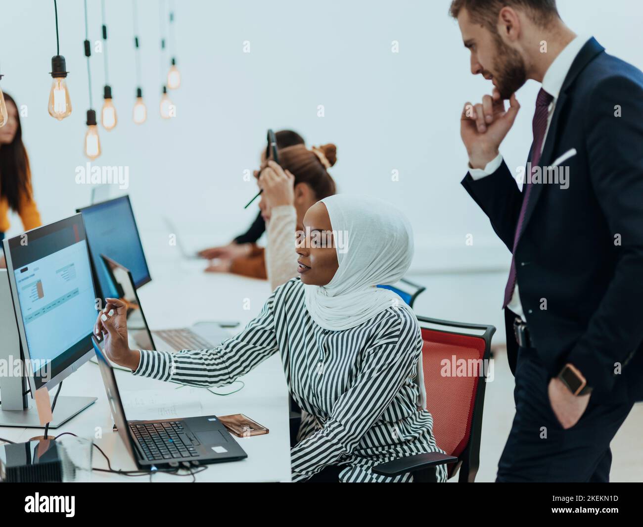 Group of multi-ethnic colleagues working on desktop computers, laptop ...