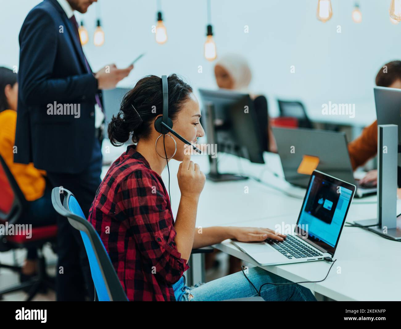 Group of multi-ethnic colleagues working on desktop computers, laptop ...