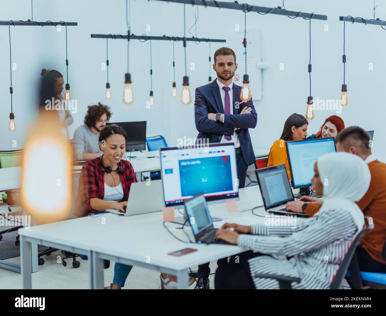 Group of multi-ethnic colleagues working on desktop computers, laptop ...