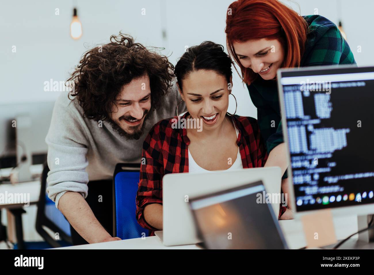 Group of multi-ethnic colleagues working on desktop computers, laptop ...
