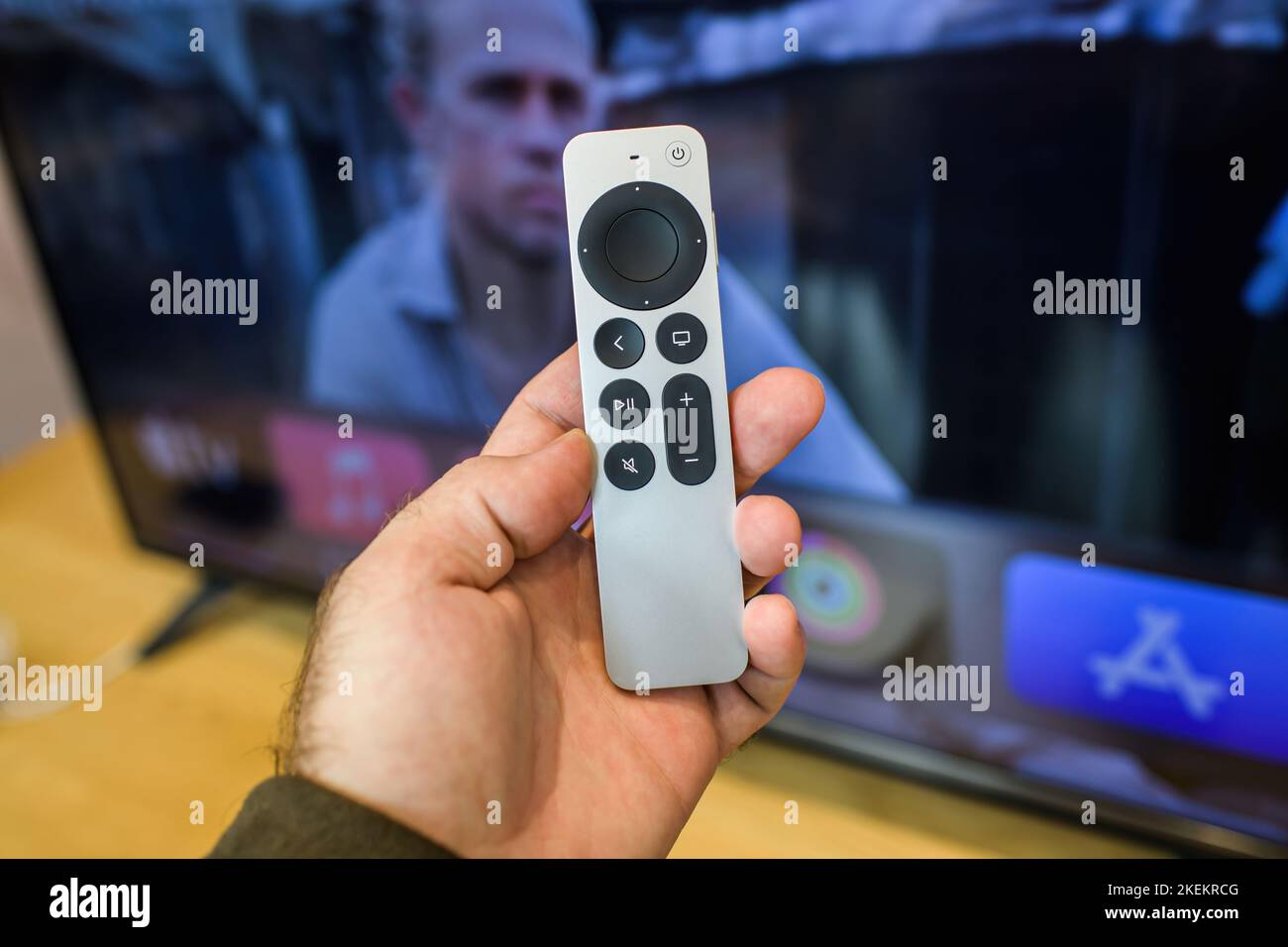 Paris, France - Oct 28, 2022: Scroll content to watch tv Male hand close-up of new Apple Computers Siri Remote voice recognition of new Apple TV 4K touch-enabled clickpad Stock Photo