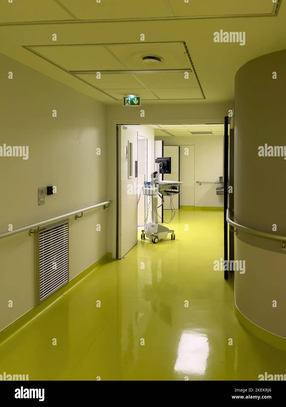 Large hospital corridor with modern nurse computing workstation with large LCD screen and multiple input and storage data Stock Photo