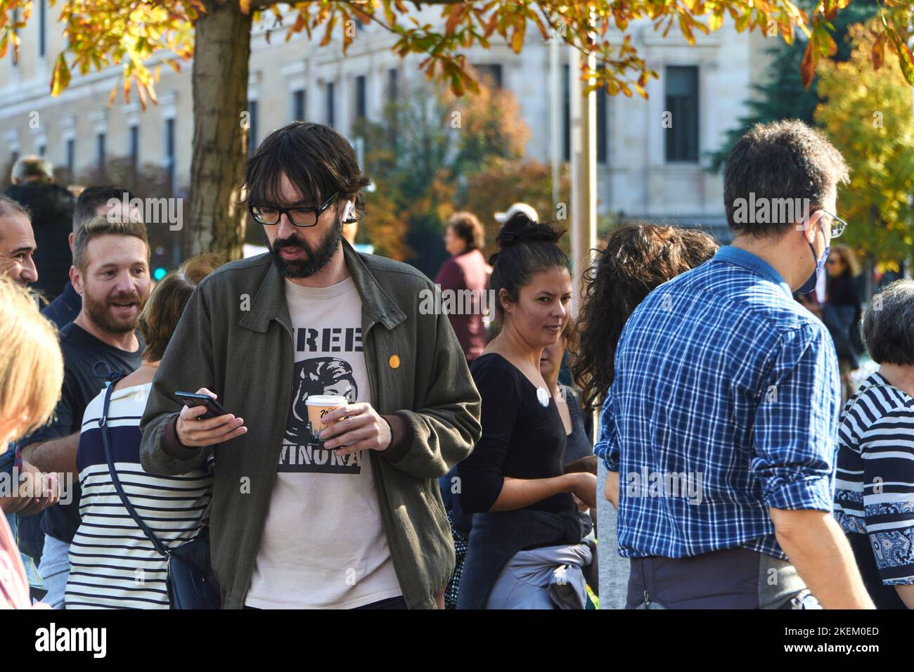 TV conductor Quique Peinado looking at his mobile phone while attending the demonstration in favor of Madrid public healthcare on 13th nov 22 Stock Photo