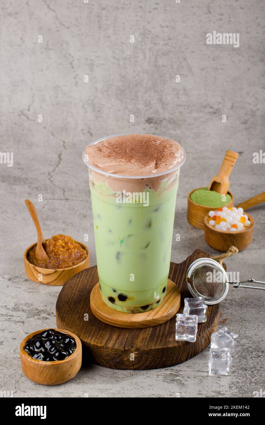 https://c8.alamy.com/comp/2KEM142/boba-or-tapioca-pearls-is-taiwan-bubble-milk-tea-in-plastic-cup-with-matcha-flavor-and-cream-on-texture-background-summers-refreshment-2KEM142.jpg