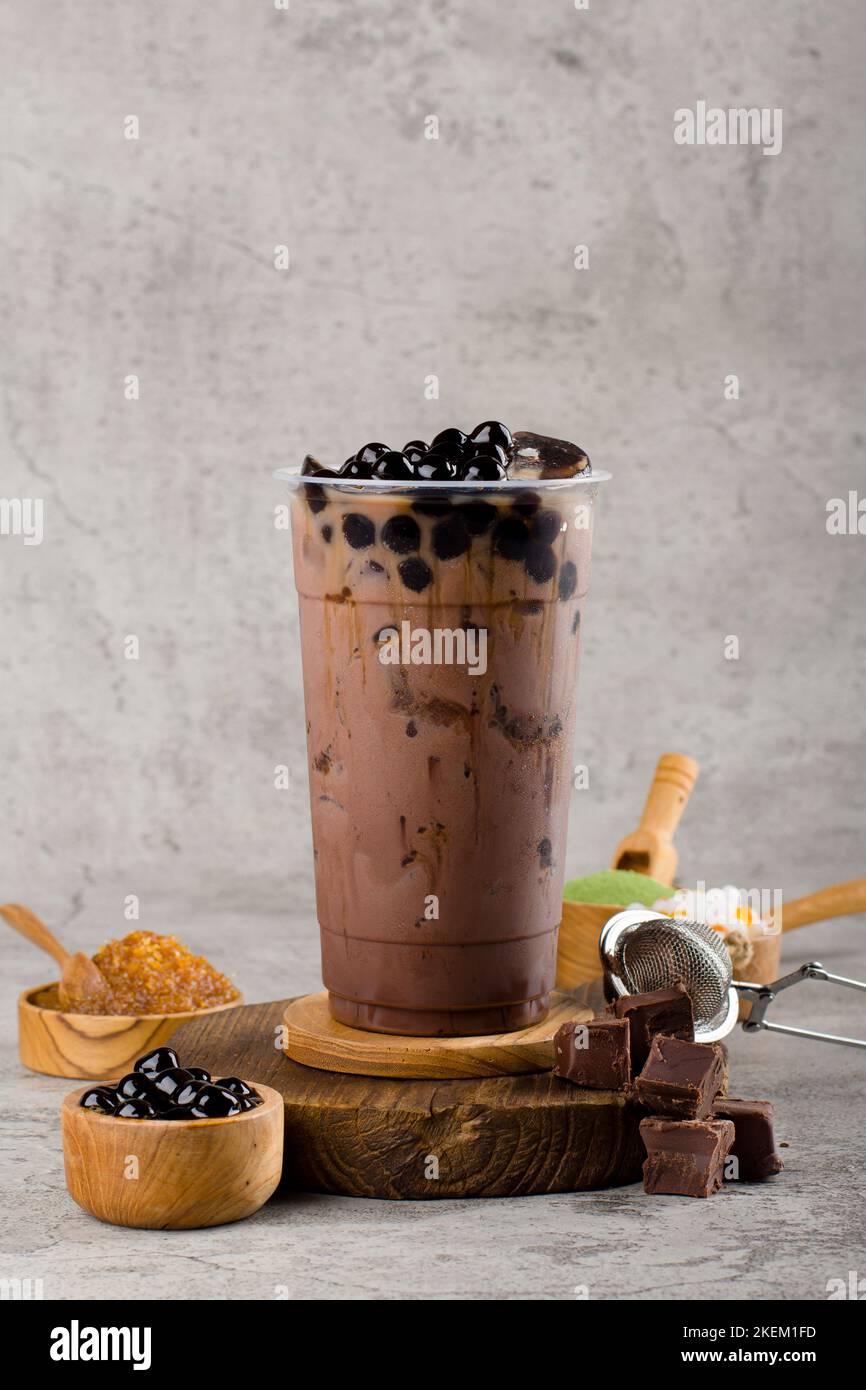 https://c8.alamy.com/comp/2KEM1FD/boba-or-tapioca-pearls-is-taiwan-bubble-milk-tea-in-plastic-cup-with-chocolate-flavor-on-texture-background-summers-refreshment-2KEM1FD.jpg