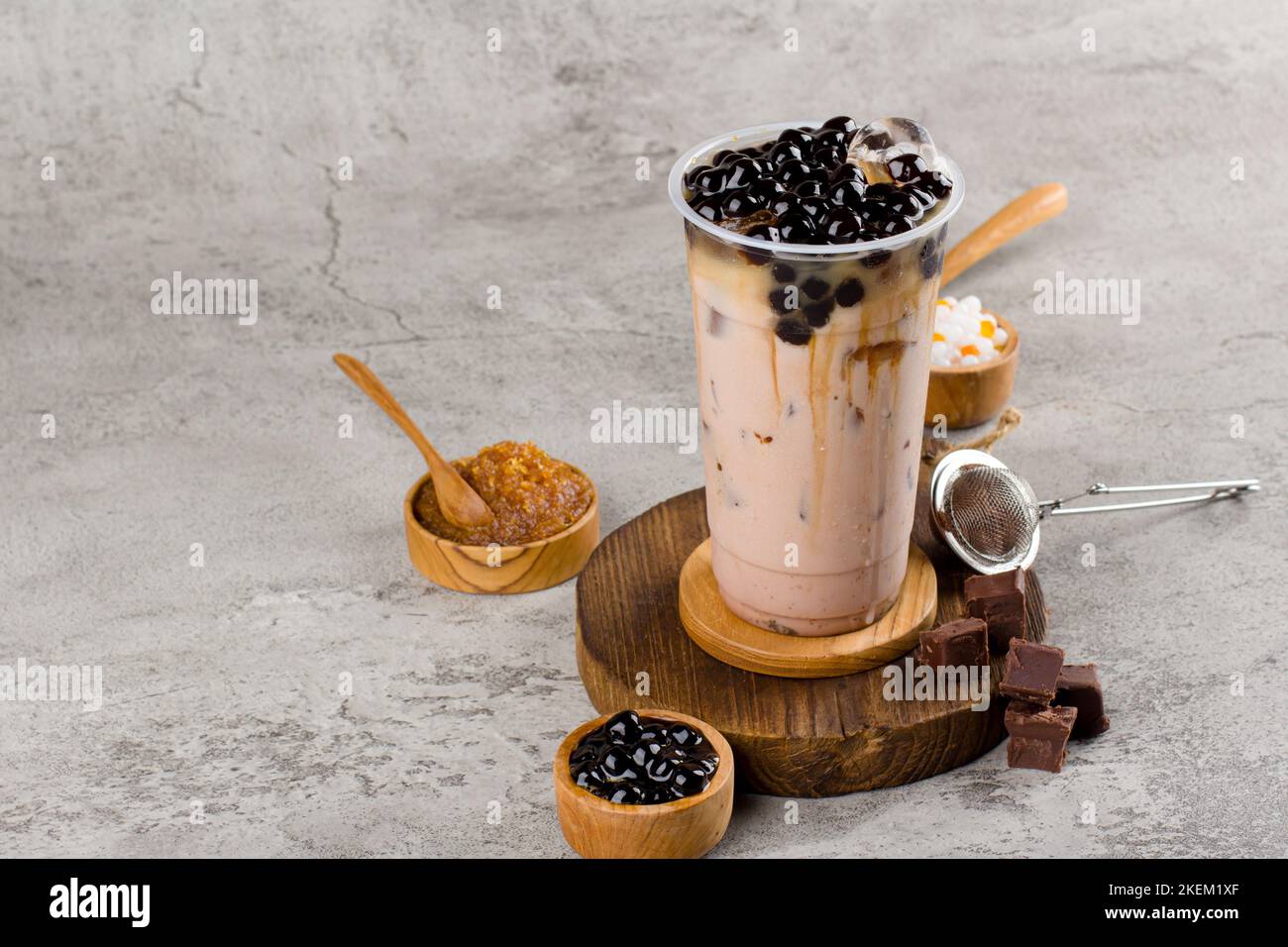 https://c8.alamy.com/comp/2KEM1XF/boba-or-tapioca-pearls-is-taiwan-bubble-milk-tea-in-plastic-cup-with-coffee-flavor-on-texture-background-summers-refreshment-2KEM1XF.jpg