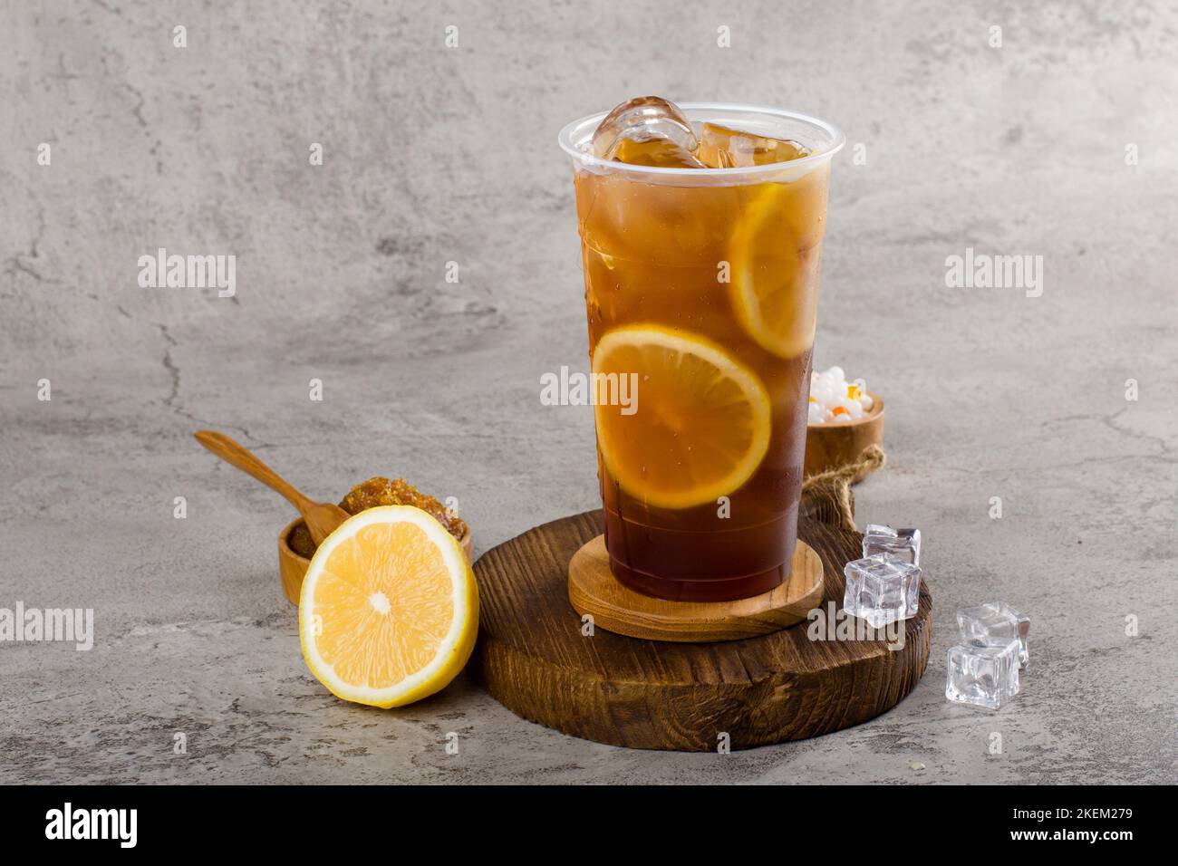 ice tea with slice of lemon in plastic cup on the wooden background Stock  Photo - Alamy