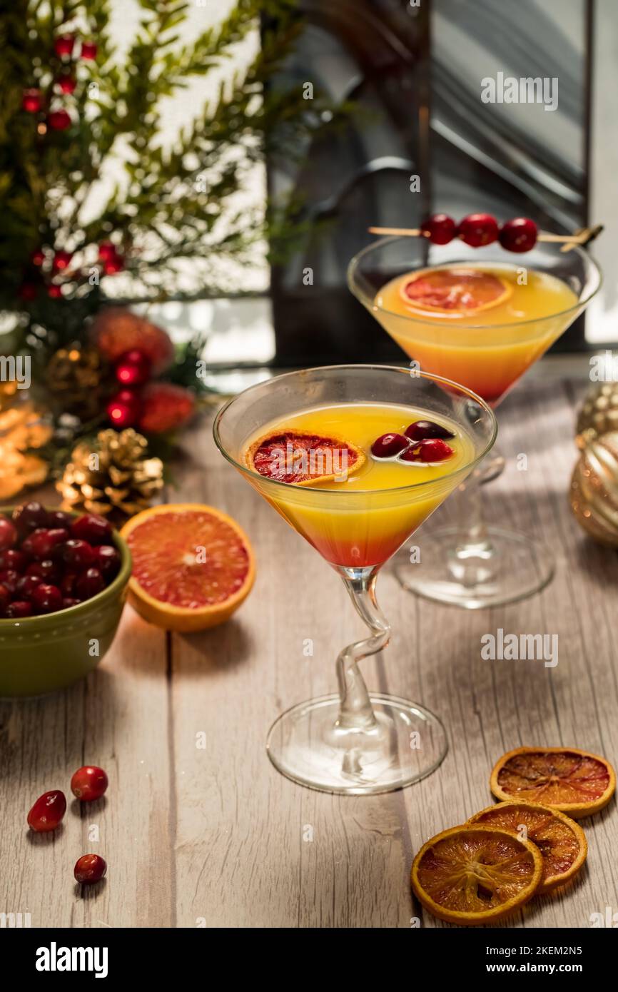 Two refreshing Cranberry Orange Mimosas against a festive background. Stock Photo