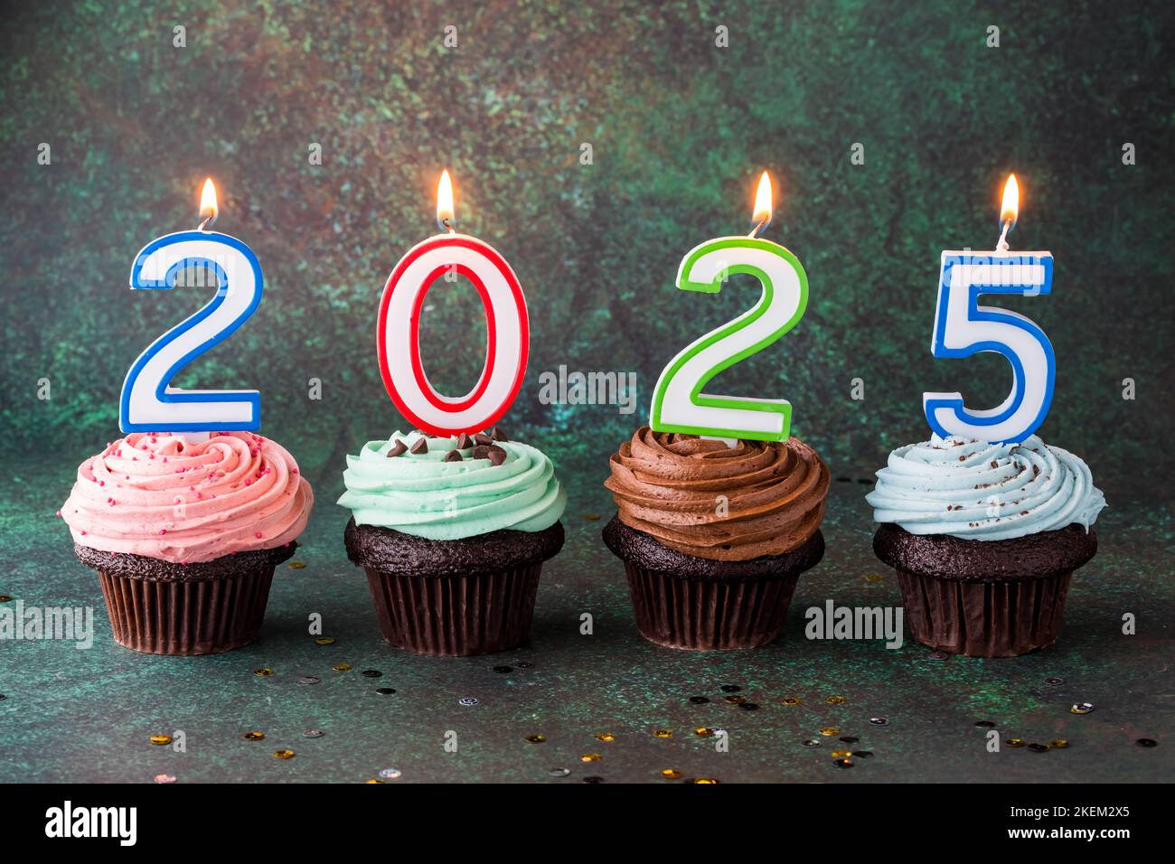 Delicious buttercream frosted cupcakes topped with 2025 candles Stock