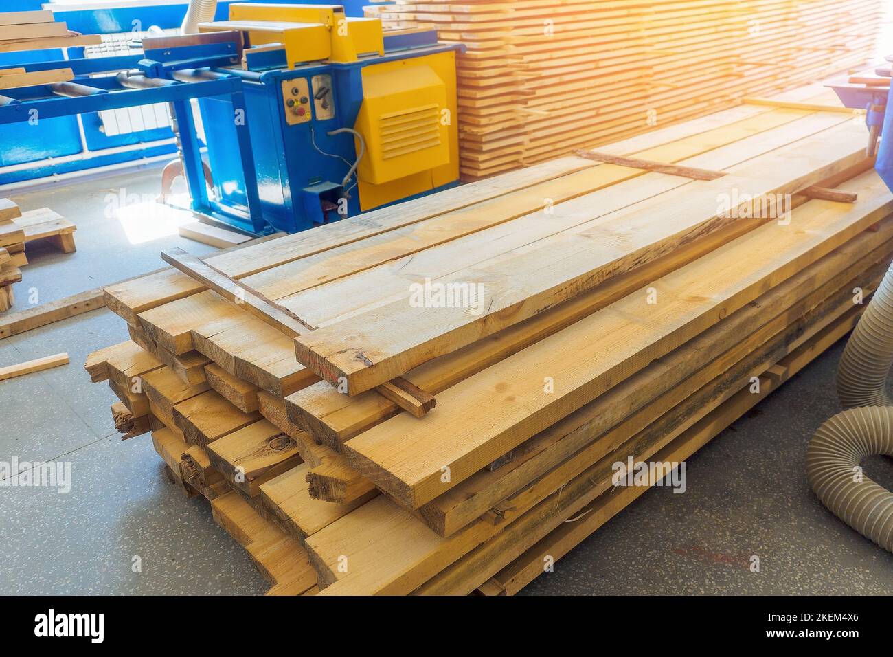 Many wooden planks stacked in carpentry workshop. Building material. Background.. Stock Photo