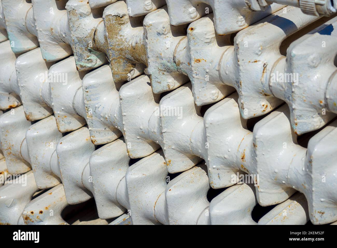 Old cast iron batteries or heating radiators stacked. Scrap metal and