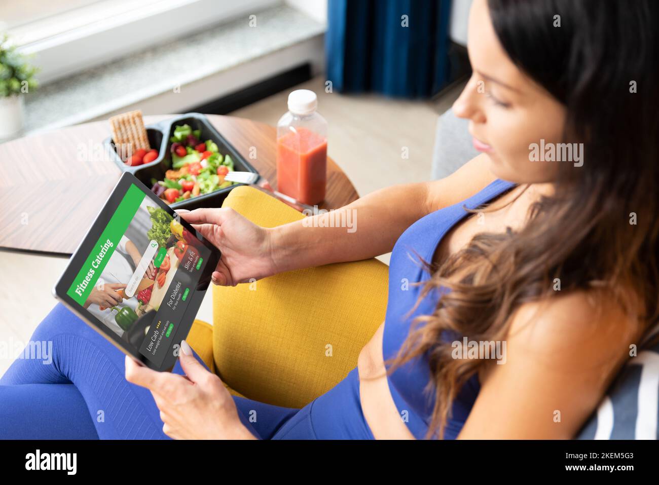 Fit woman eating healthy food at home. Healthy lifestyle concept with fitness catering Stock Photo