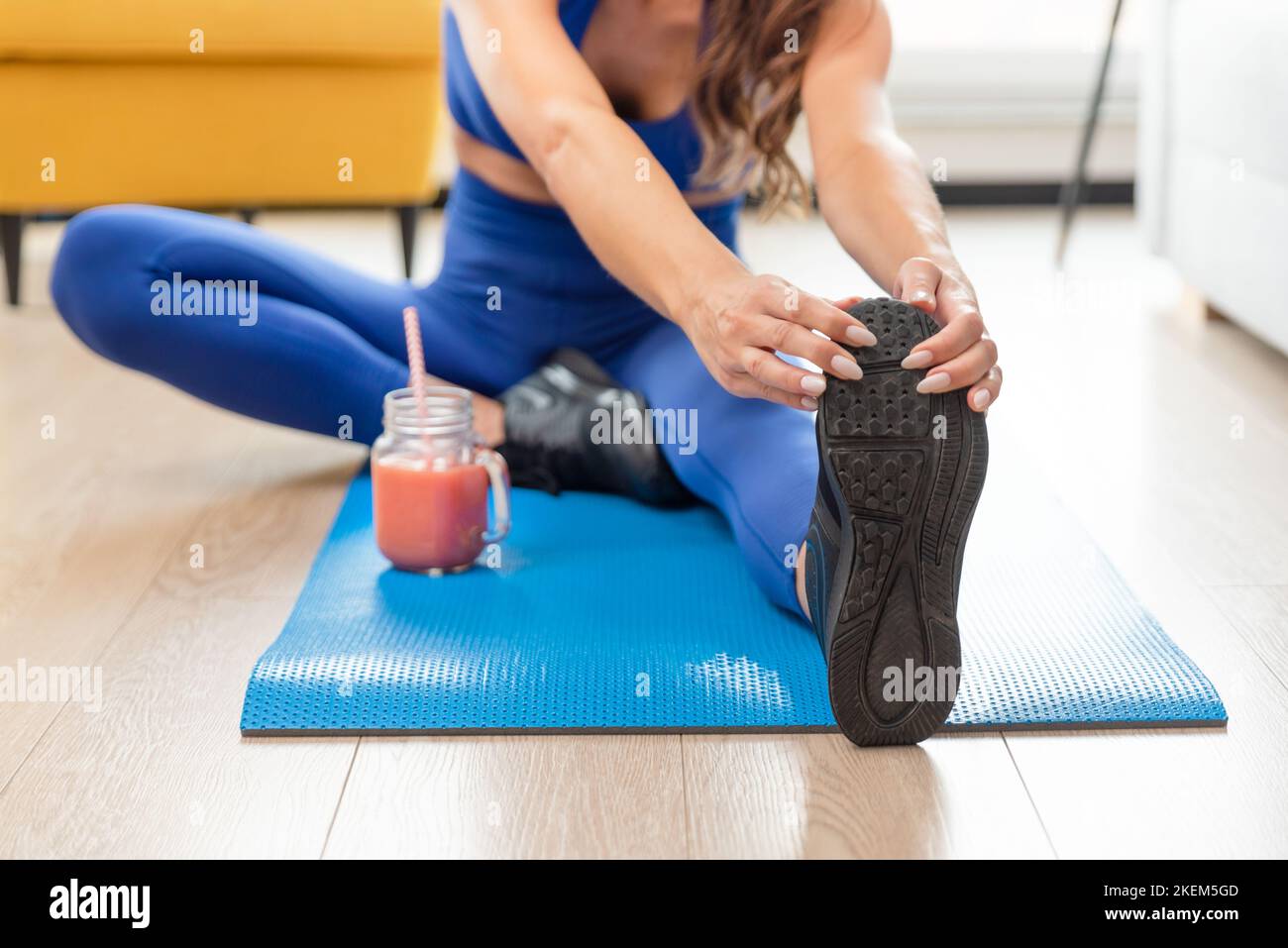 Woman exercising at home. Workout, home fitness concept with online tutorials Stock Photo