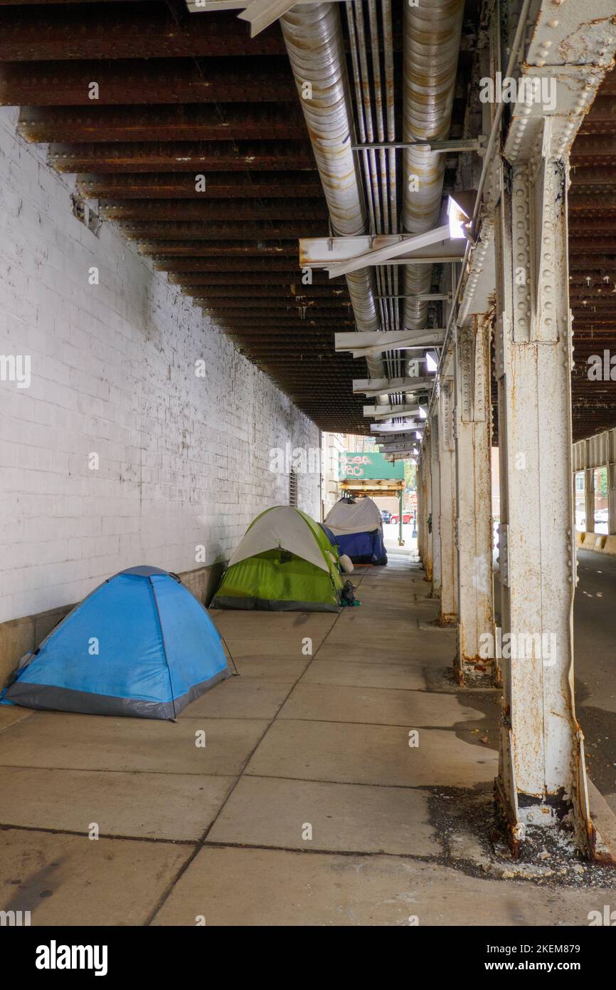 Homeless encampment under railroad viaduct, Milwaukee Avenue. Chicago, Illinois near Fulton Market. Stock Photo