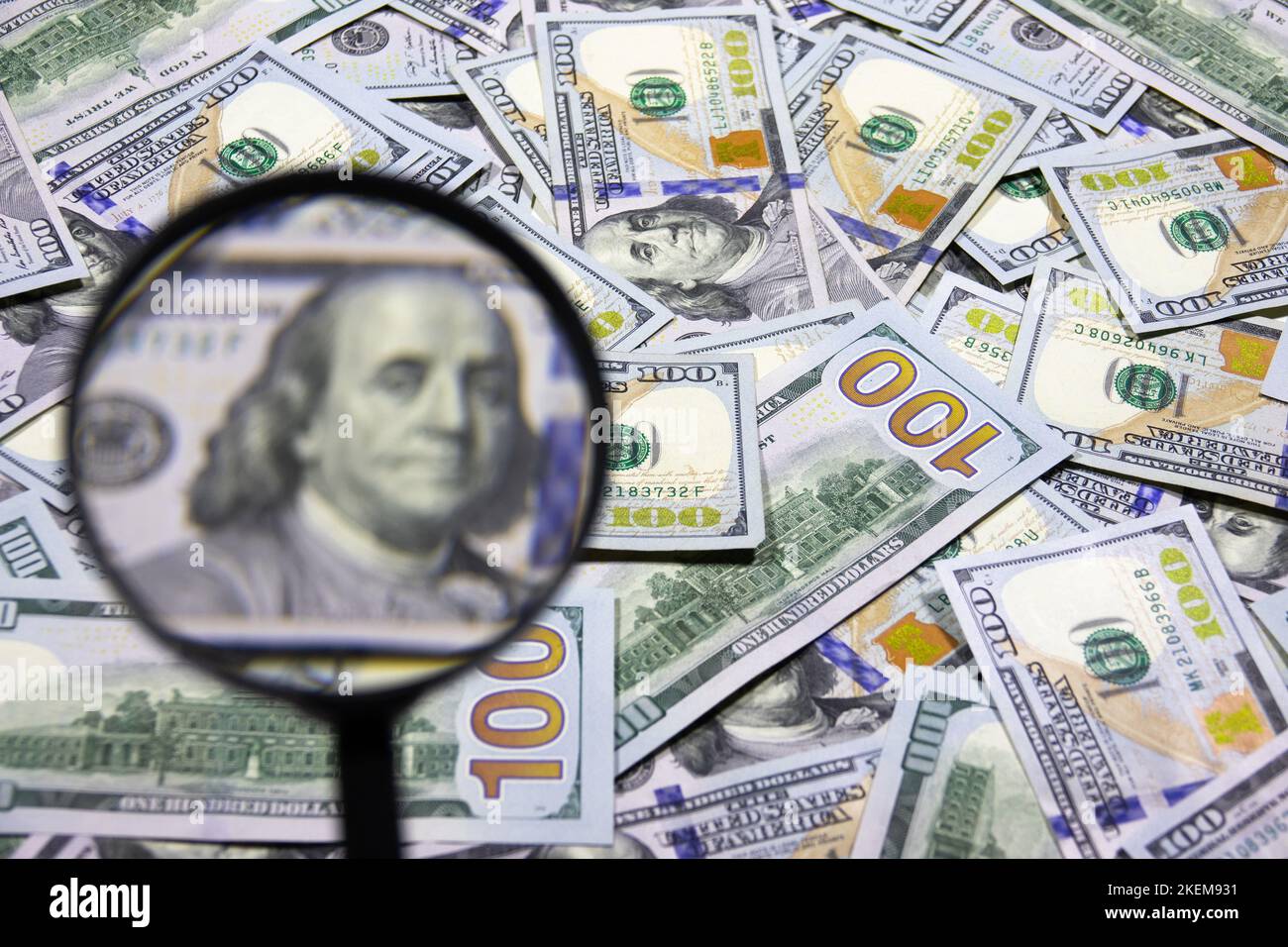 One hundred dollar banknote under magnifying glass. USA national currency. Banking and financial concept. Blurred background Stock Photo