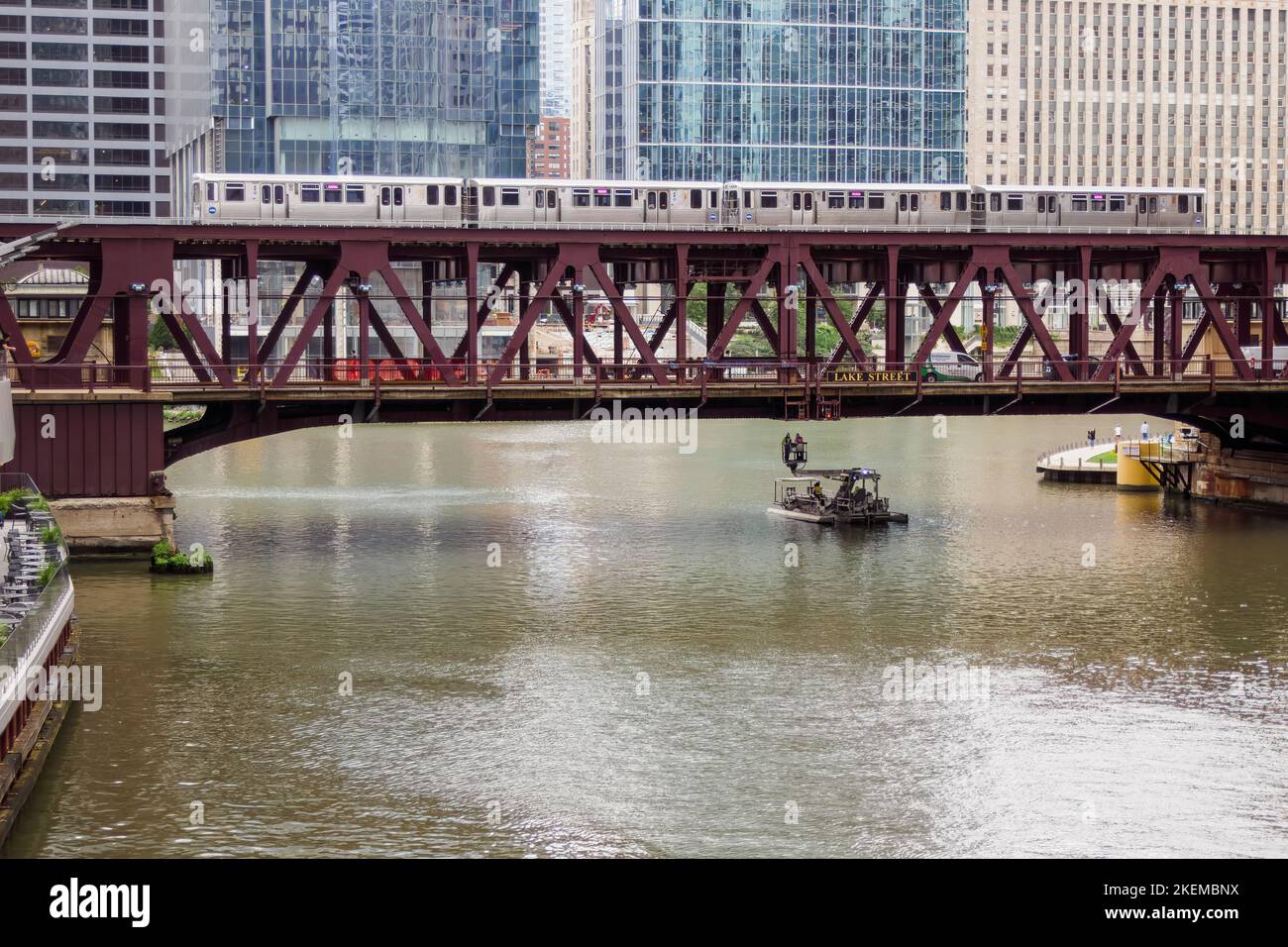 Lake Street Bridge Chicago with bridge inspection boat and inspectors. CTA Pink Line train crossing bridge. Stock Photo