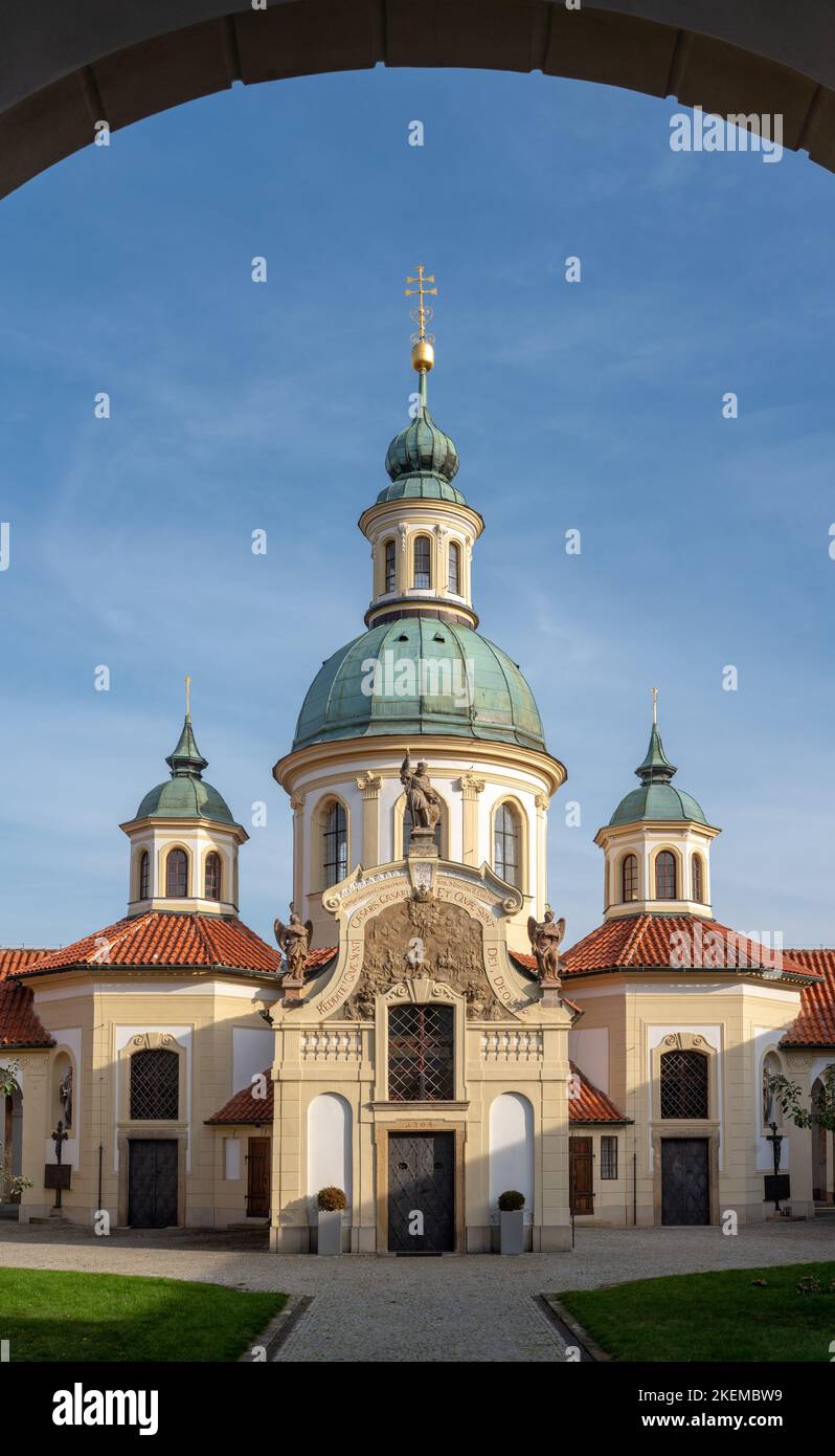 Shrine of Our Lady Victorious at Bílá hora in Prague, baroque Catholic complex from 18th century. Church in the center as seen from a cloister arch. Stock Photo