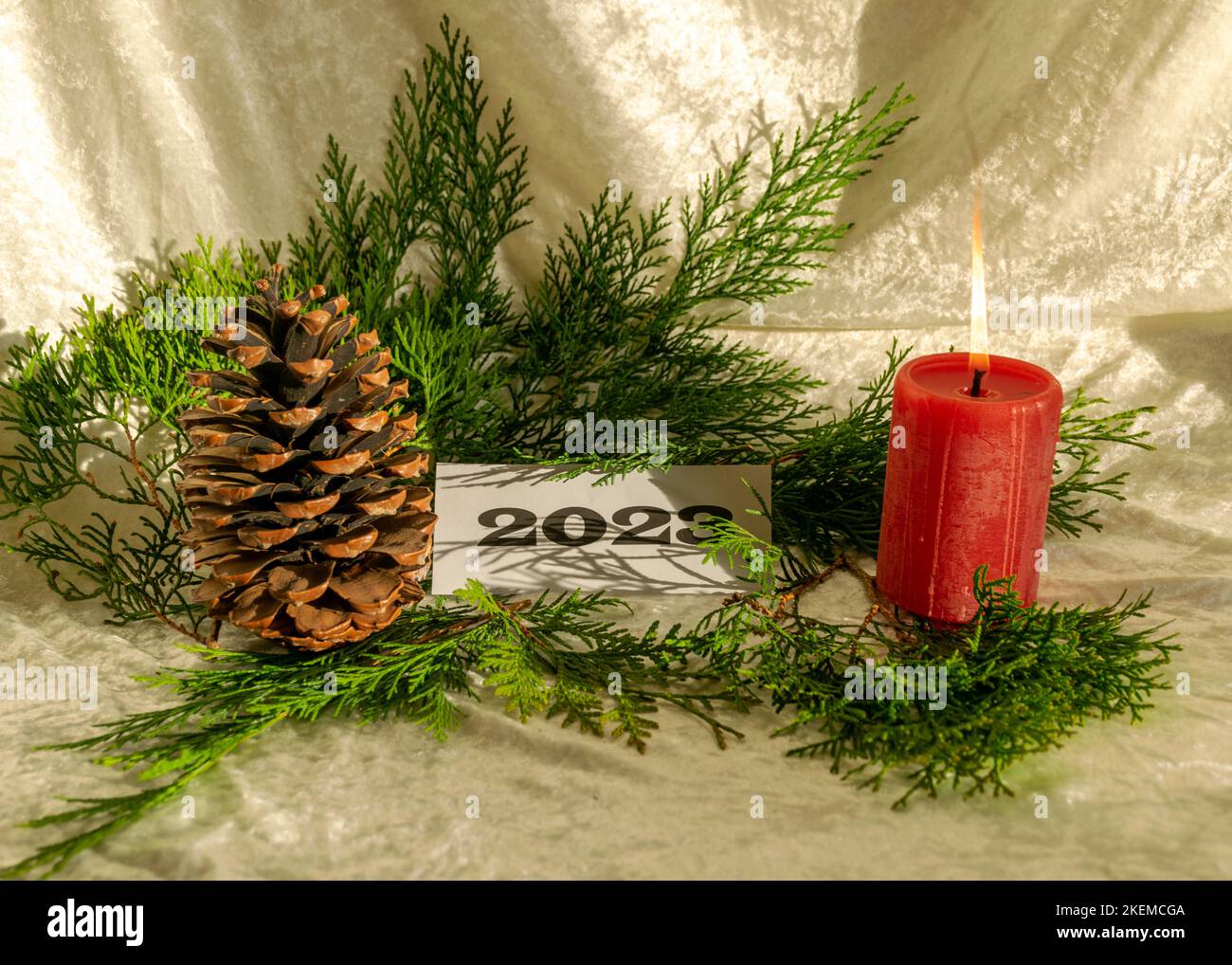 Christmas decorations on light background, red candle and text 2023 ...