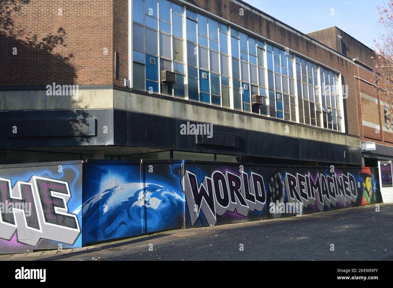 13th November 2022, Swansea, Wales, United Kingdom. A disused shop building and art-covered fence in Swansea City Centre. Stock Photo