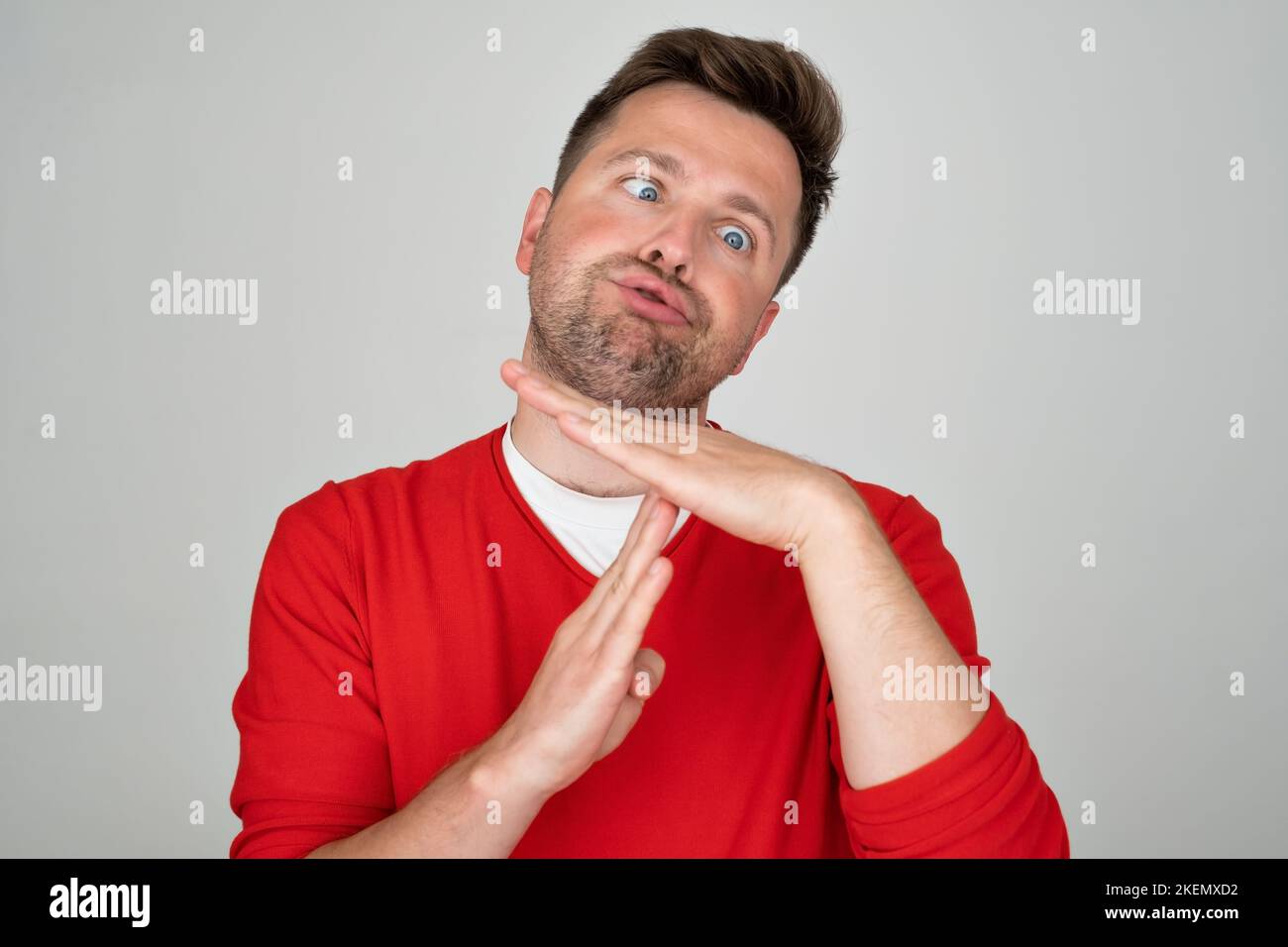Caucasian mature man showing with hand palm arm r time out sport symbol.  Stock Photo