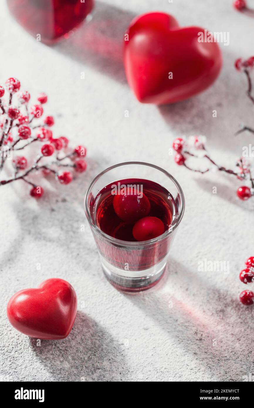 Red cocktail, vodka or liqueur and Heart shape decorations Stock Photo