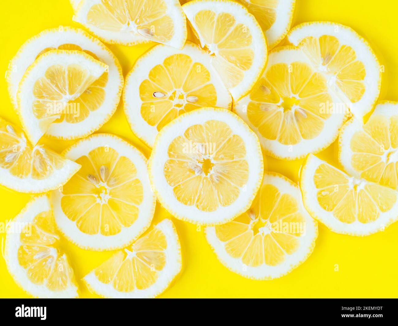 Lemon citrus slices in water, bold yellow texture summer background ...