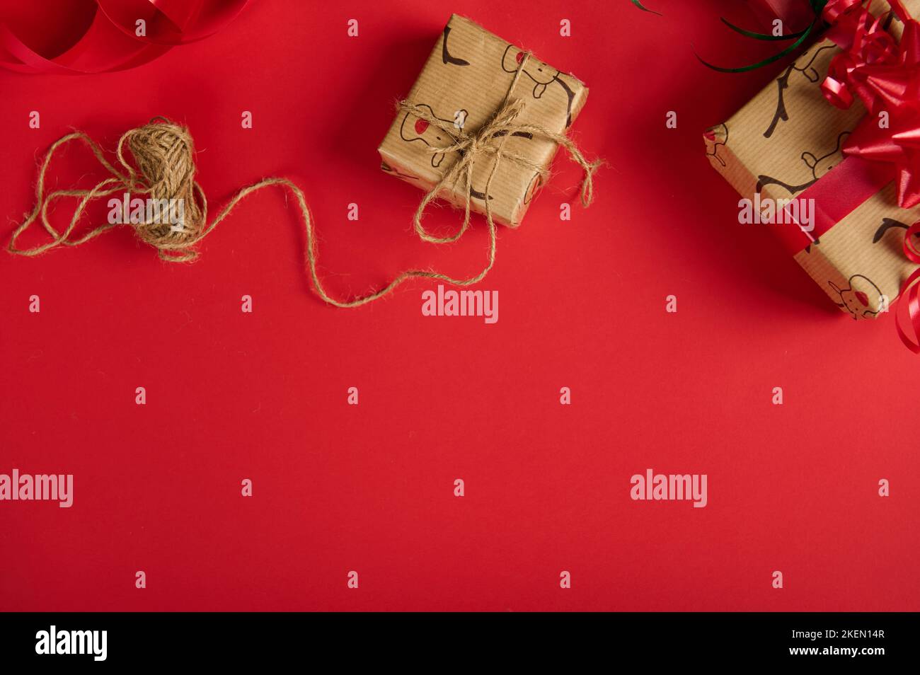 Christmas presents wrapped in wrapping paper with deer pattern and tied ...