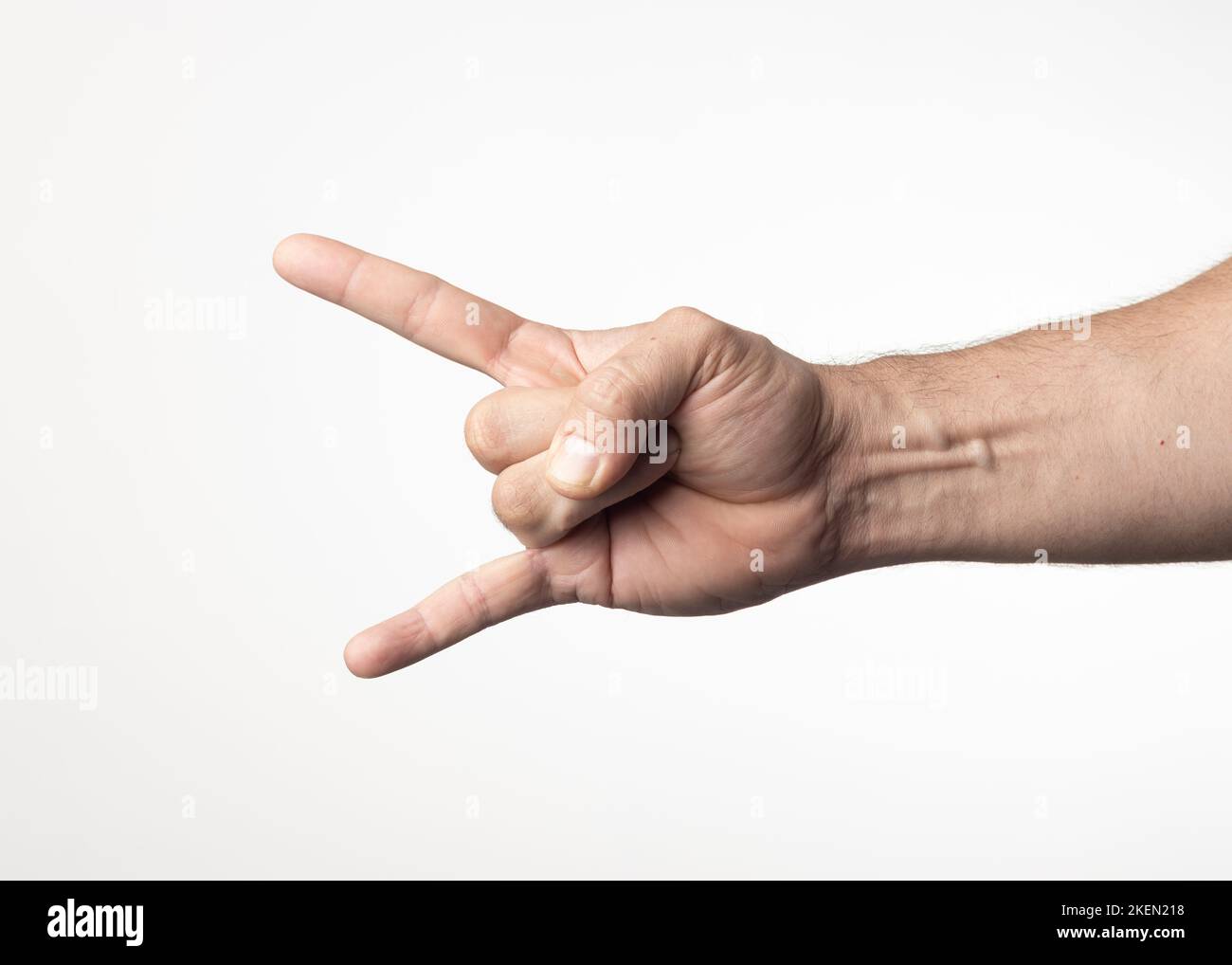 A man's hand and arm on a nuclear white background, showing a gesture of greeting approval or positivity. Stock Photo