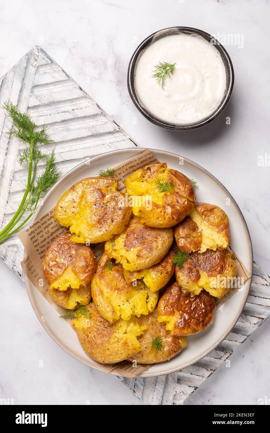 smashed potato on parchment paper Stock Photo Alamy