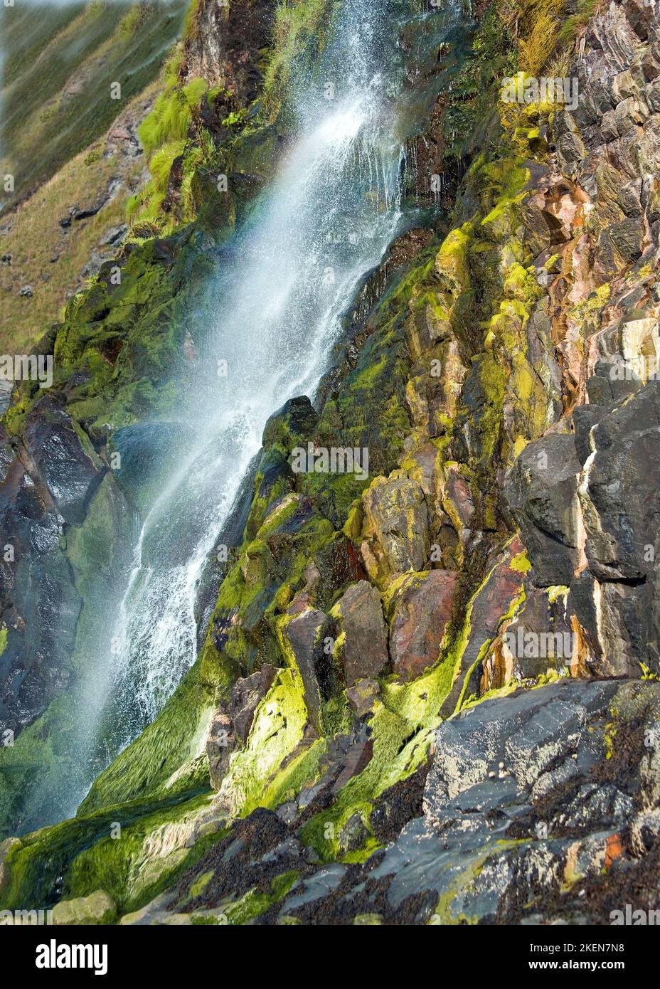 The river Saith waterfall tumbling down cliff face onto Tresaith Beach in Cardigan Bay Wales Stock Photo