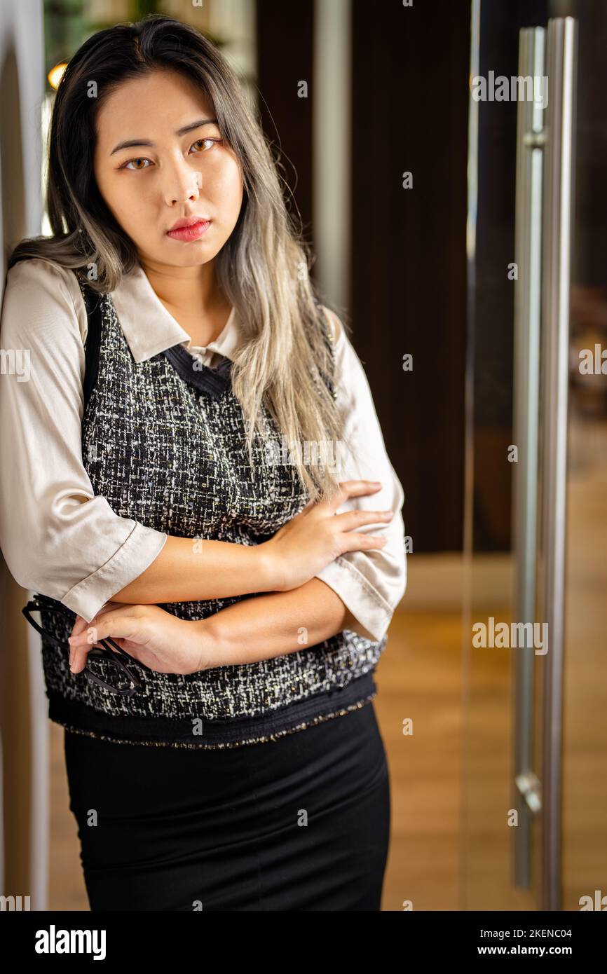 Young Female Data Scientist Waiting at the Door to a Conference  Room Stock Photo