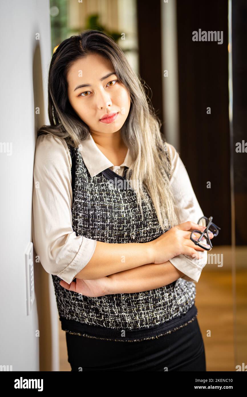 Young Female Data Scientist Waiting at the Door to a Conference  Room Stock Photo