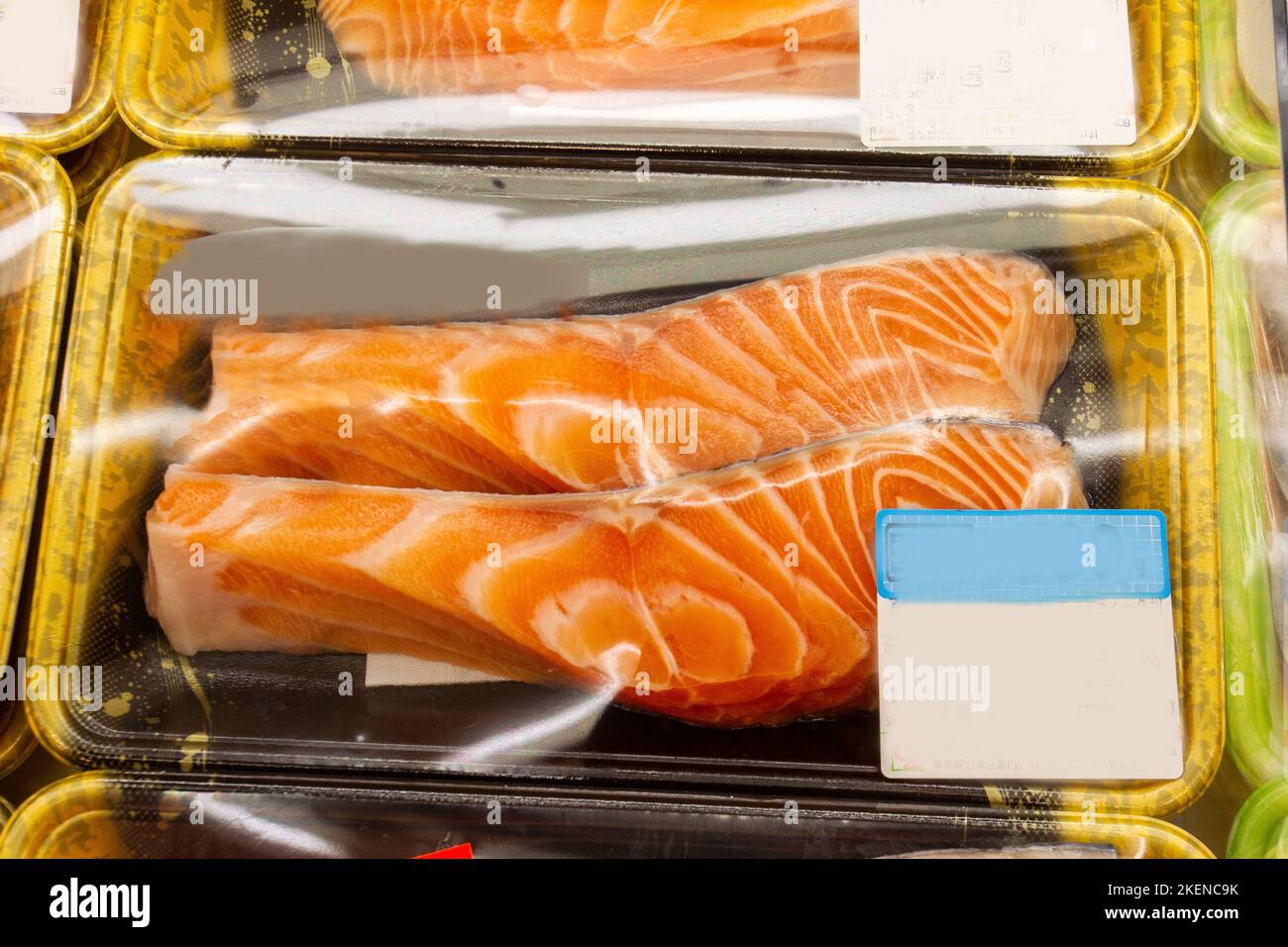 Delicious piece of fatty good raw salmon packaged in a cold grocery store display case Stock