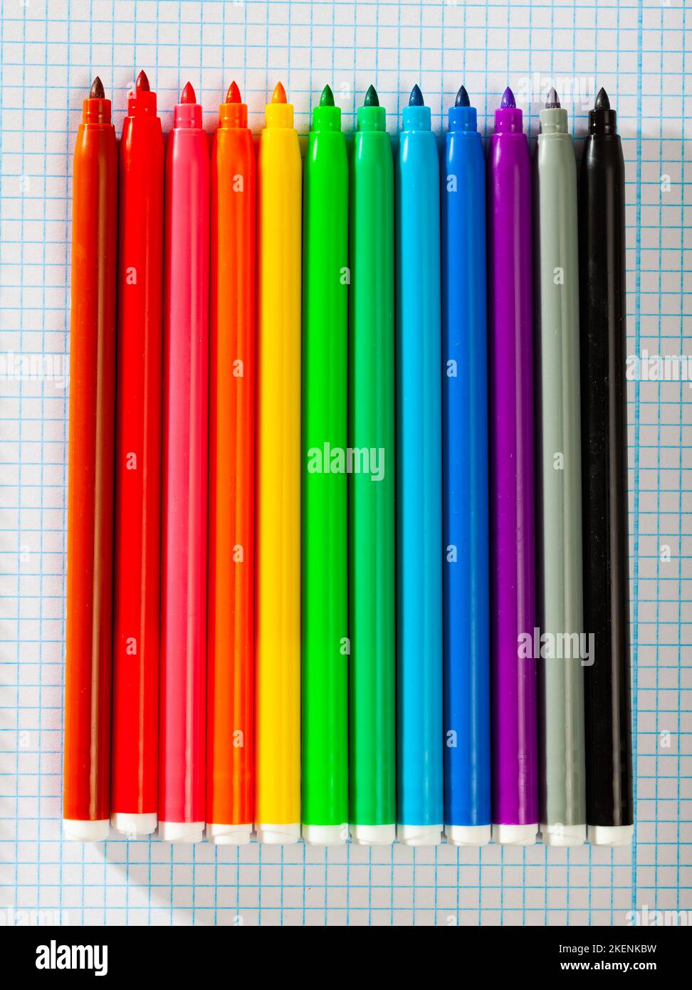 Image of opened multicolored markers on notepad Stock Photo