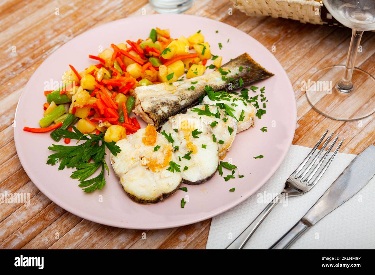 Oven baked hake with vegetable garnish Stock Photo