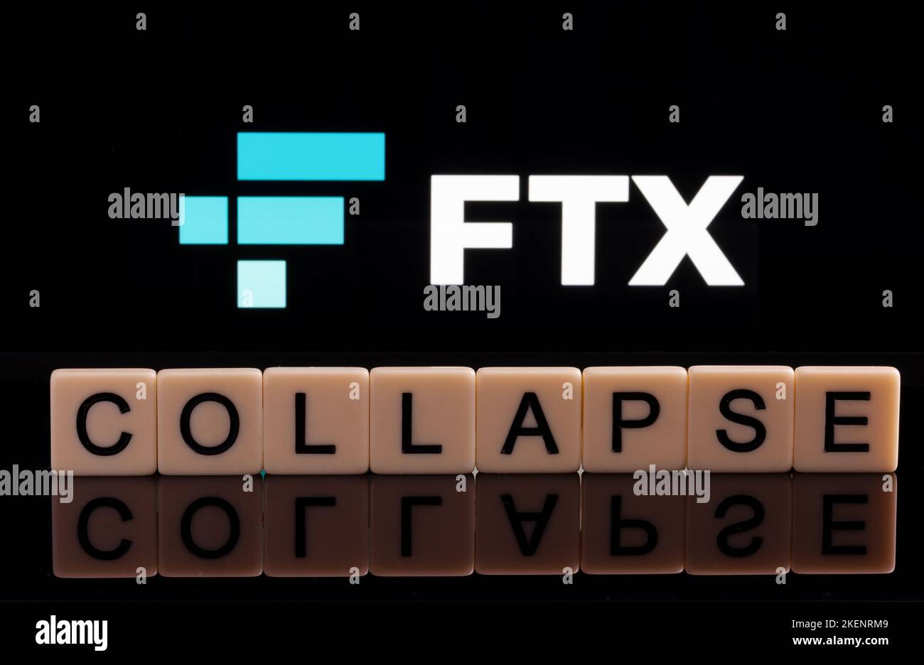 COLLAPSE word made of letters seen in front and blurred FTX Cryptocurrency Exchange logo seen on display. Concept for company bankruptcy. Stafford, Un Stock Photo