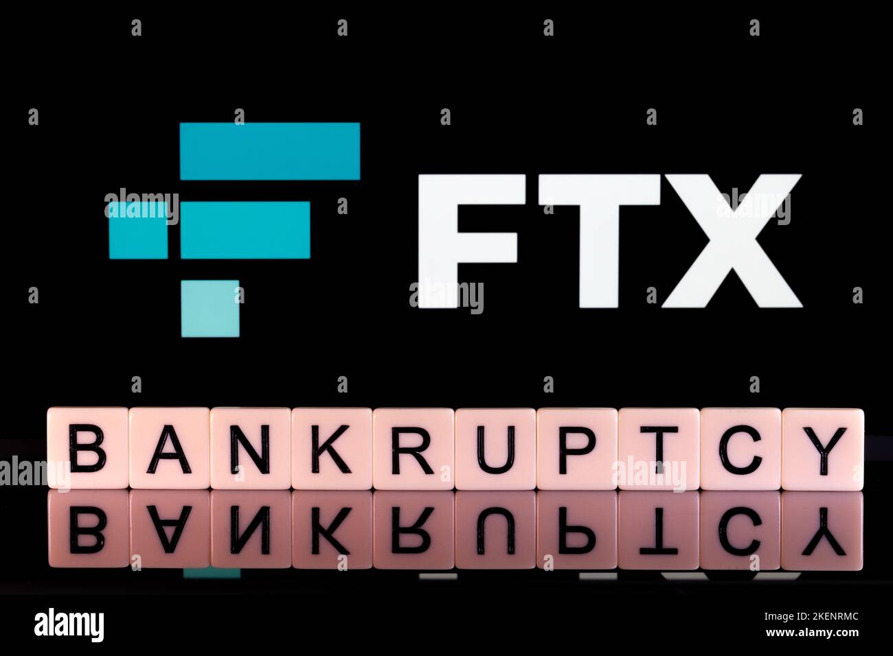 BANKRUPTCY word made of letters seen in front and blurred FTX Cryptocurrency Exchange company logo seen on display. Concept for company bankruptcy. St Stock Photo