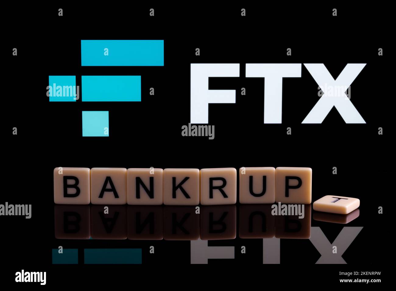BANKRUPT word made of letters seen in front and blurred FTX Cryptocurrency Exchange company logo seen on display. Concept. Stafford, United Kindom, No Stock Photo