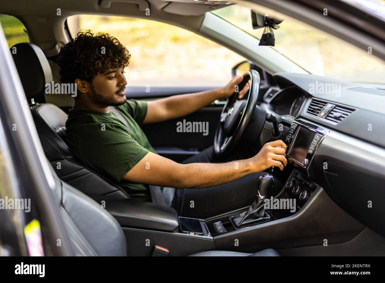 Man is going to drive, looking for some nice music Stock Photo