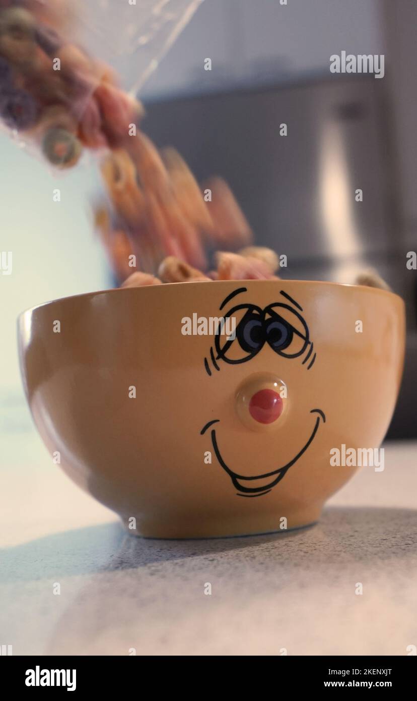Cereal being poured into funny bowl Stock Photo Alamy