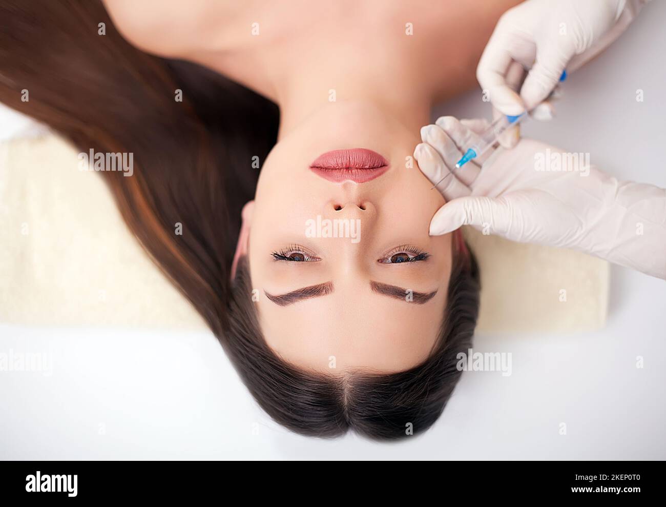 Hand Injecting Botox Close up of hands of cosmetologist making botox injection in female ...