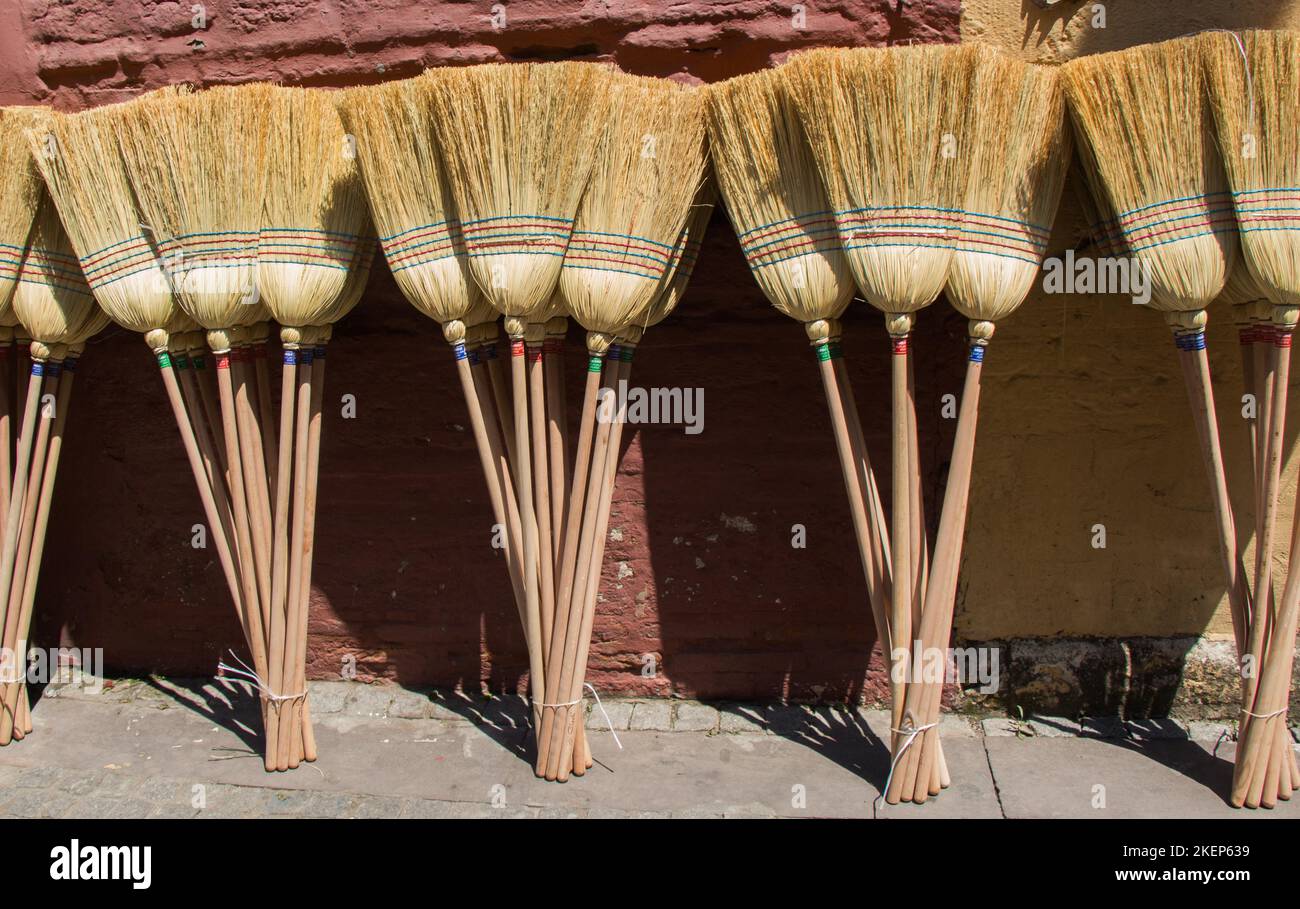 Set of yellow straw broom in a bazaar Stock Photo Alamy
