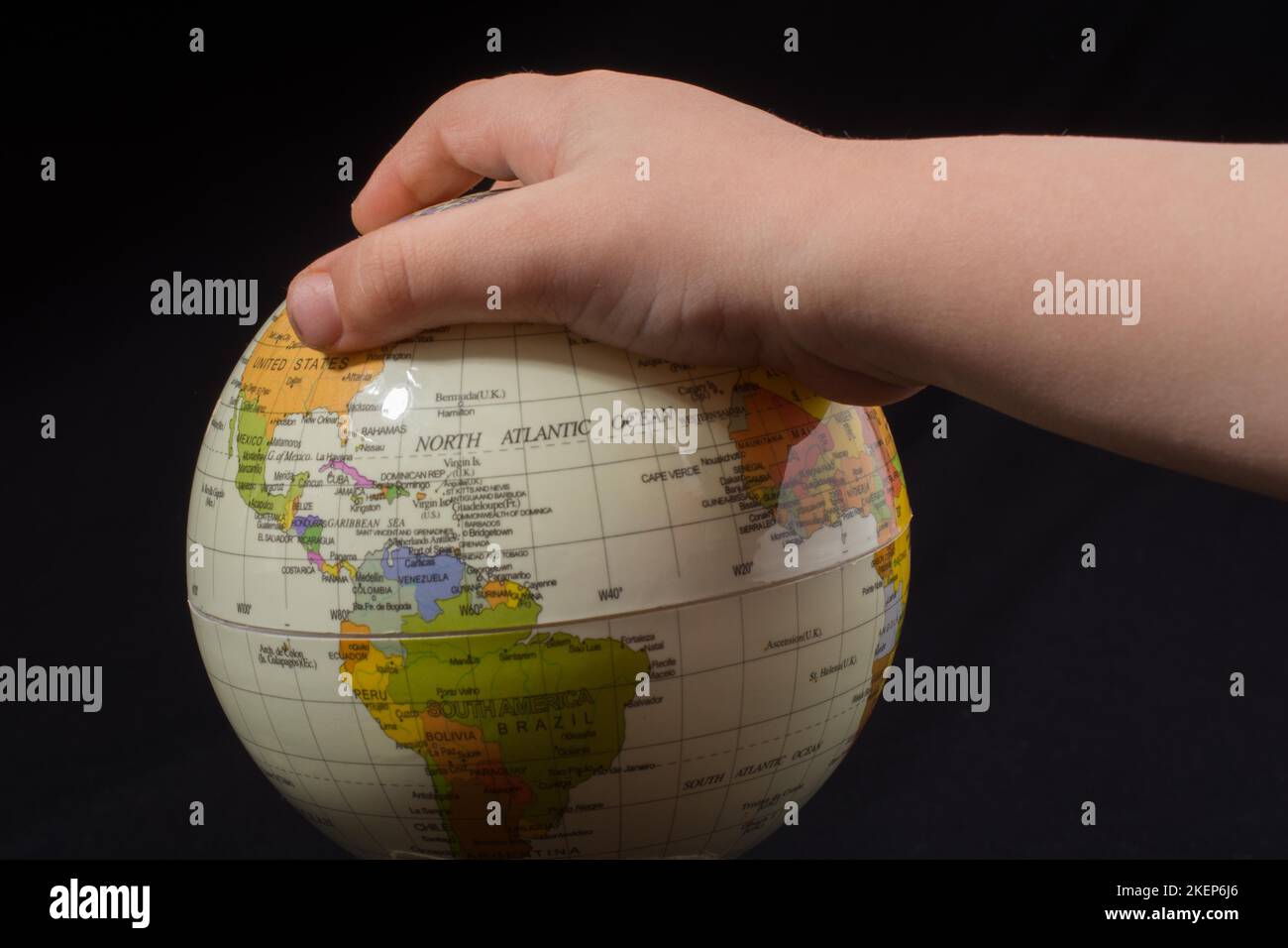 Hand holding a globe with map on it Stock Photo - Alamy