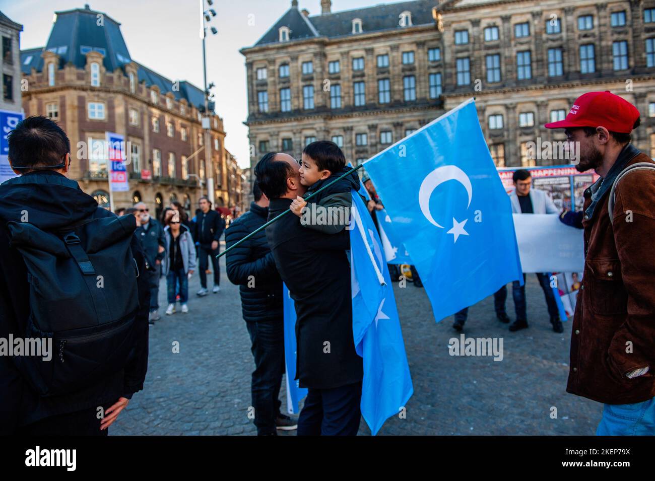 An Uyghur man is seen hugging his son while holding Uyghur flags during an event to commemorate the 'National Day of East Turkistan'. November 12th marks the Republic Day of East Turkistan, which is also known as Xinjiang Uyghur Autonomous Region of China, the Uyghur community living in The Netherlands, organized an event to commemorate the 'National Day of East Turkistan' and to keep fighting against the Chinese government in order to take back their independence. The Chinese government has reportedly detained more than a million Muslims in reeducation camps. Most of the people who have been Stock Photo
