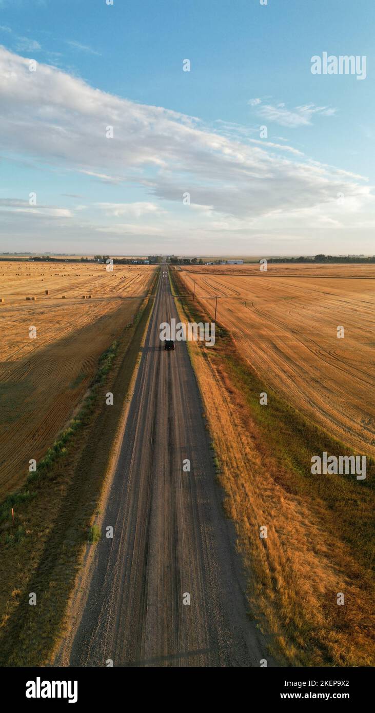 Drone view during sunrise over a farm hay field and river in Alberta Canada Stock Photo