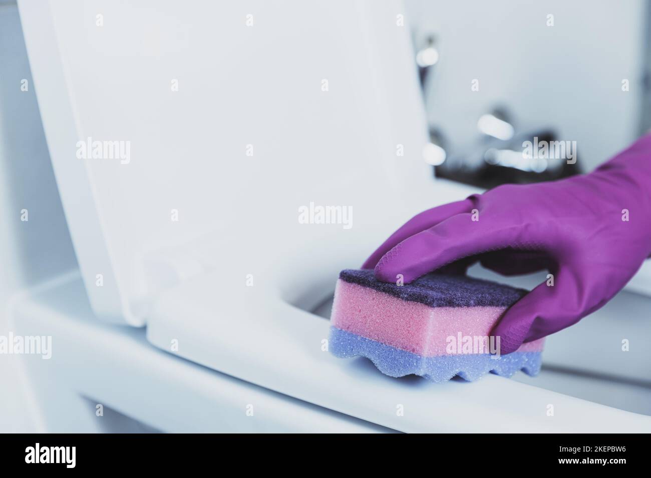 Close up on woman hand gloved in blue rubber protective gloves